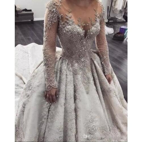 Luxury Arabic Long Sleeves Wedding Dresses 2020 New Elegant Sheer Neck Illusion Back Lace Beaded Crystals Bridal Gowns