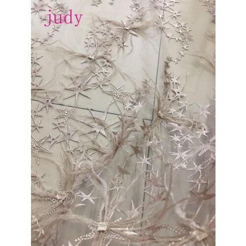 Light gold embroidered star pattern feather fringed French cloth used in dress and wedding dress fashion design