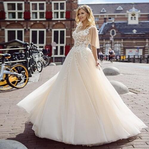 Illusion Scoop Champagne Wedding Dresses with Chic Leaf Lace Appliques Lantern Sleeves A Line Buttons Back Bridal Gowns 2021