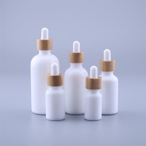 12pcs 10ML 15ML 30ML 50ML 100ML Empty Cosmetic Essential Oil Packaging Round Primary White Glass Drop Bottles With Bamboo Cap