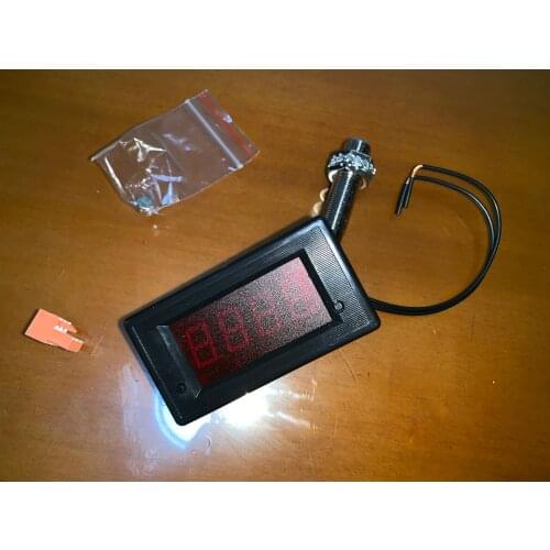 Harvester alarm tachometer with magnetic sensor speed reduction audible alarm