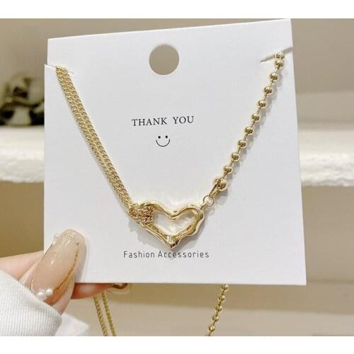 U-Magical Korean Trendy Asymmetric Love Heart Pendant Necklace for Women Gold Chain Beaded Tie Metal Hollow Necklace Jewelry