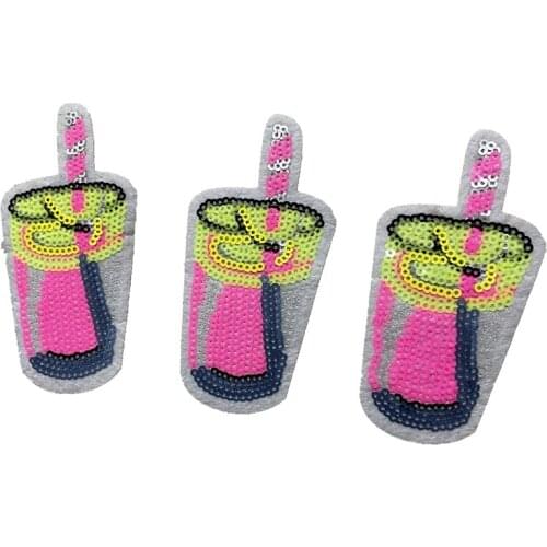 Cup of juice drinking yellow and pink sequined jeans patch
