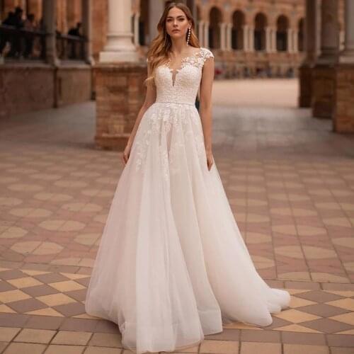 Elegant A-Line Wedding Dresses 2021 Cap Sleeve Sheer Scoop Neck Lace Appliques Button Tulle Bridal Gown Beads Belt Sweep Train