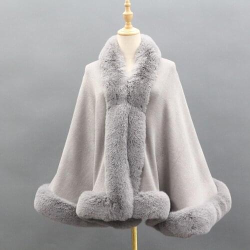 Cape shawl lady keeps warm with a stylish knit shawl modeled after a faux fur collar in winter mix spinning poncho