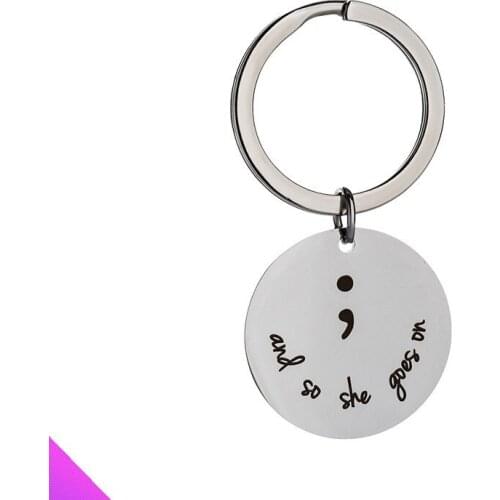 Keychain stainless steel disc pendant engraved with“And so she goes on