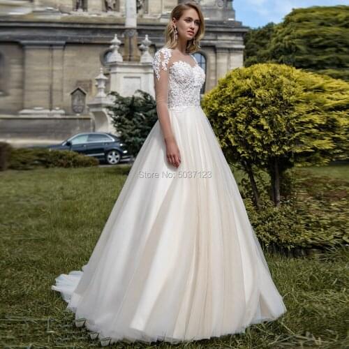 2020 Light Champagne Wedding Dresses Long Sleeves Lace Appliques Button Illusion Sweep Train Bridal Gowns Vestido de noiva