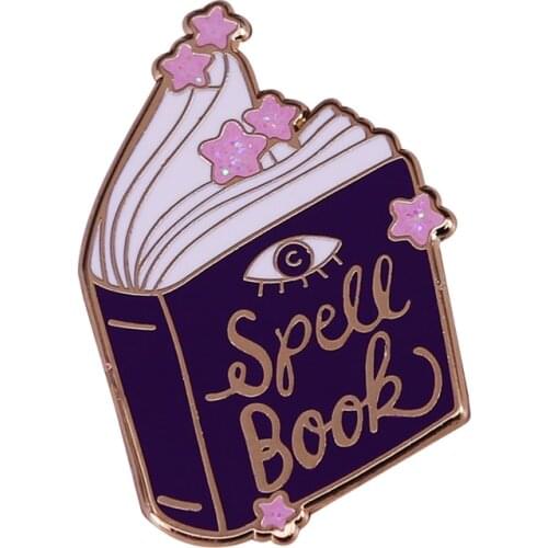 This lovely spell book pin with pink glitter star embellishments is the perfect way to show your pagan pride and magic