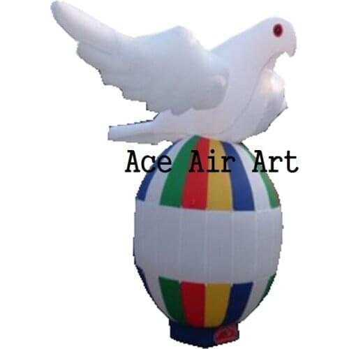 4m high white flying inflatable pigeon with stretched wings standing on colorful eggs/ball for advertising/event decotation