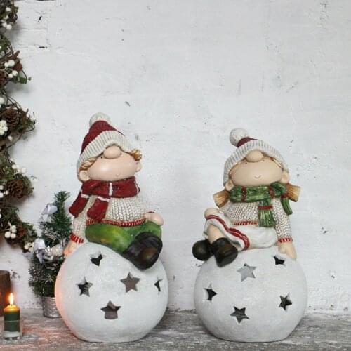 A LITTLE GIRL SITTING ON SNOWBALL CANDLESTICK ORNAMENT GARDEN STAR CANDLESTICK DECORATION WINDOW DISPLAY