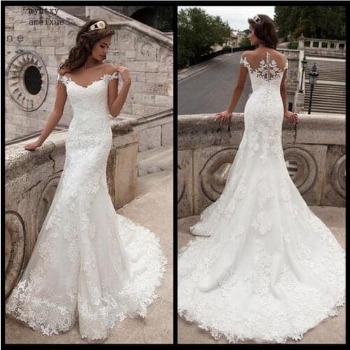 Sexy 2020 White Mermaid Wedding Dress Sleeveless Appliqued Tulle Buttons Back Boho Wedding Gown Long Train Bride Dress