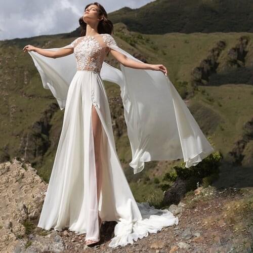 Bohemian Chiffon Wedding Dress 2021 Long Flare Sleeves A-Line Side Slit Lace Appliques Backless Sweep Train Bridal Gown With Cap