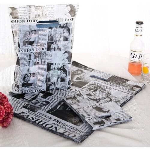 25x35cm 50pcs/lot Black Newspaper Style Plastic Handle Clothes Gift Bags Hot Wedding Gift Plastic Packaging Bags With Handle