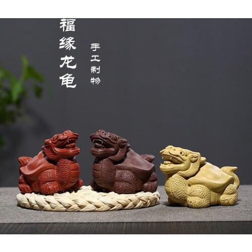 Sand sculpture, luck, dragon and tortoise tea ceremony, surrounding with a piece of tea to play a hair substitute