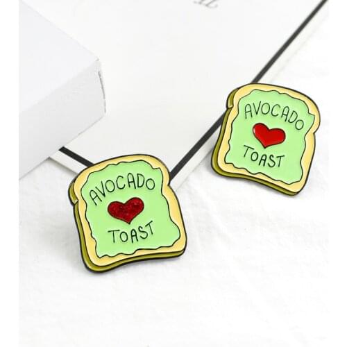 Baked green toast bread with a small red love brooch in the middle to give a small gift to someone you love is a companionship