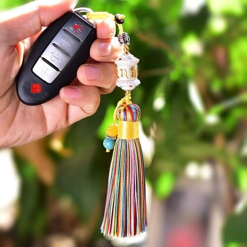 The key chain of the Tibetan Buddhist Scripture wheel with colorful tassels is a symbol of a smooth journey for the wearer