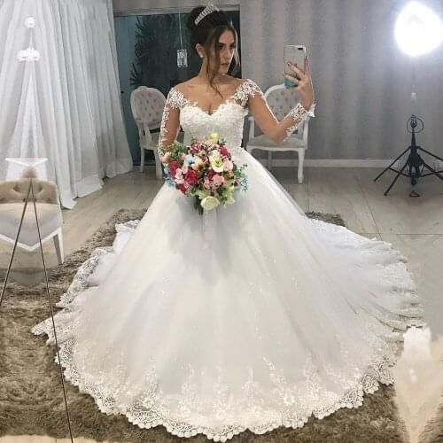 YIWUMENSA Modest Design Wedding Dresses Sheer Jewel Neck Long Sleeves Button Back Luxury Appliques Ball Gown Bridal Dresses Boho