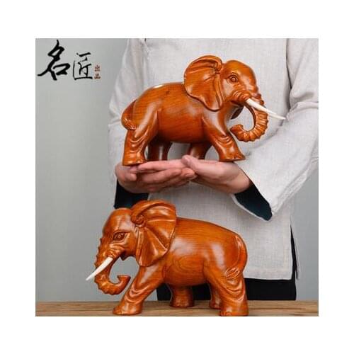 A pair elephants were carved out yellow flowers pear wood home decoration statue factory direct selling