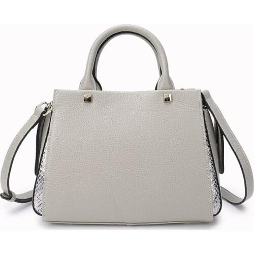 New head leather, European and American retro color contrast straddle womens fashion brand wings bag leather womens bag handba