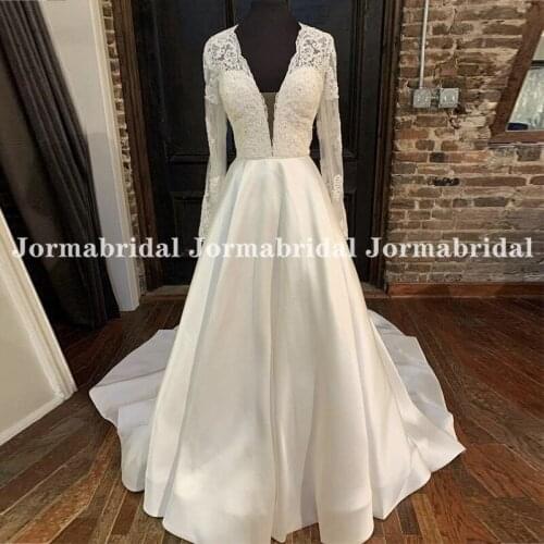 Charming A-Line Wedding Dresses Deep V-Neck Lace Appliqued Sheer Long Sleeves Bridal Dress Transparent Buttons Back Trouwjurk