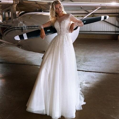 2021 New Hot Sale A-Line Wedding Dresses O Neck Illusion Full Sleeves Appliqued Sequined Luxury Pearls Long Bridal Gowns