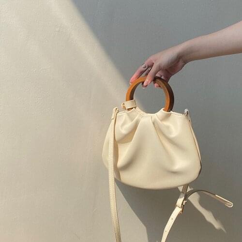 2021 Korean version of the new Retro Wooden Handle Handbag Ins one-shouldered oblique across the temperament fold small bag