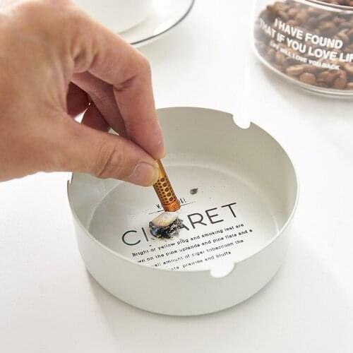 Simple modern iron ashtray on the table of creative snack bar