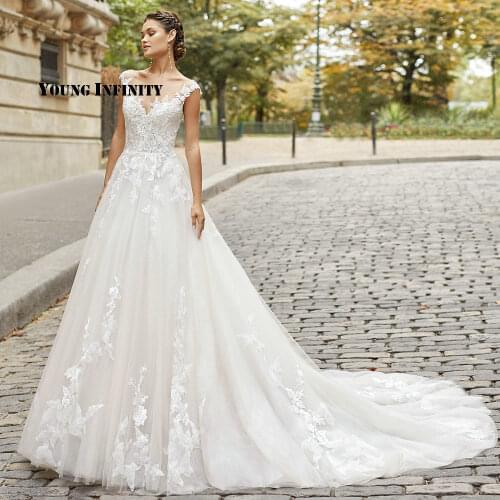 Elegant O Neck A-Line Long Tulle Wedding Dresses 2021 Sexy Illusion Back Lace Appliques Bridal Gown Long Train Buttons