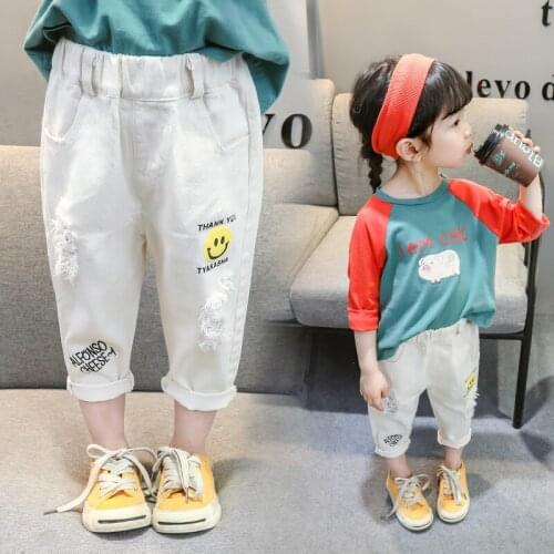 Childrens autumn new female baby smiley face ripped jeans boys Korean version of white trousers girl childrens pants