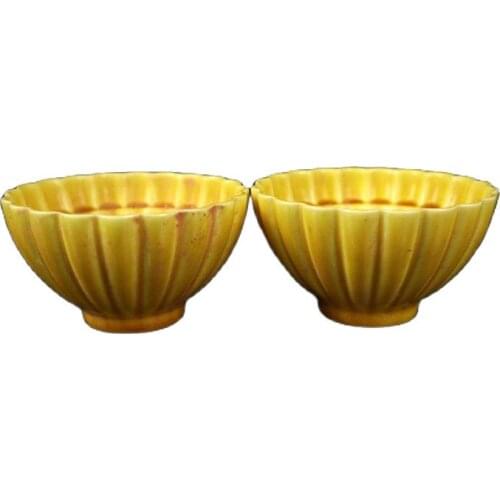 A pair of early collection ceramic yellow-glazed flower cups