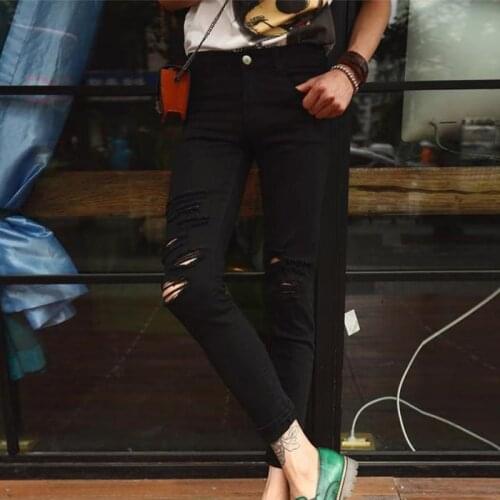 Influx male Europe and America black knee hole male jeans male Korean version of the nine pants male summer large size mens bro