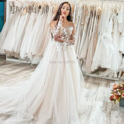 2020 Unique Lace Appliques A Line Long Sleeves Wedding Dresses See Through Scoop Neckline Buttons Back Floor Length Bridal Gowns