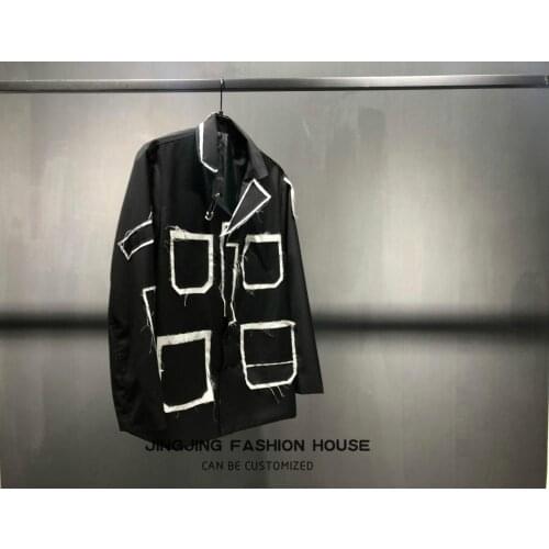 The 2019 trend pioneer black suit with patch shirt deconstructs the garment design