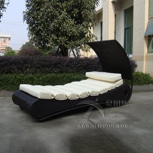 Comfortable Roofed Black Rattan Sun Lounger With White Cushion to sea port by sea