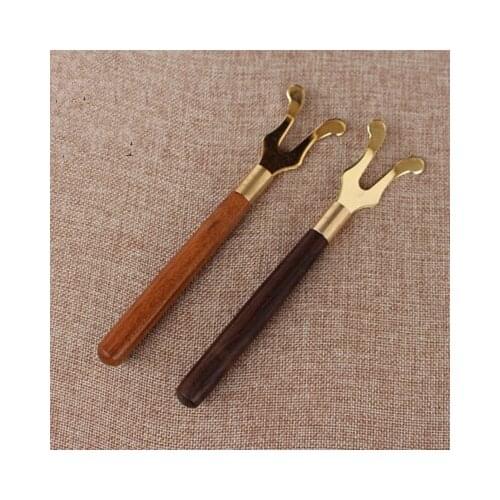 Sandalwood iron pot holder against the hot copper plating fork