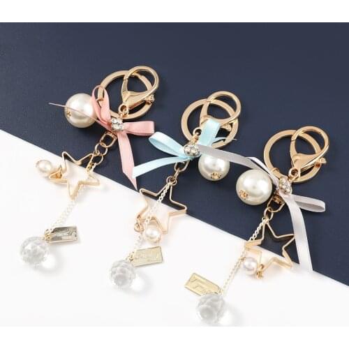 Pauli Manfi 2021 Fashion Metal Star Ribbon Bow Pendant Keychain Womens Popular Backpack Key Ring Campus Accessories
