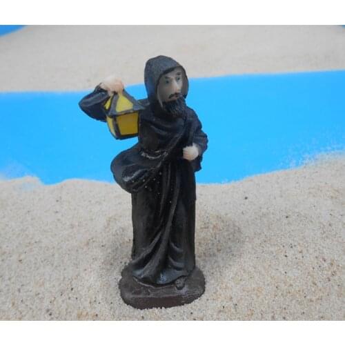 Mental sand sandbox game with Sandplay psychological product class character Priest holding a lantern