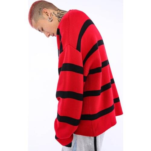 A mans ins trendy baggy sweater on the street