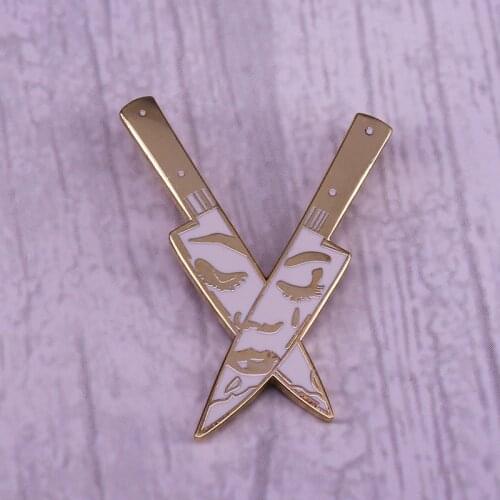 Sad face daggers brooch reflection SSDGM murder pin