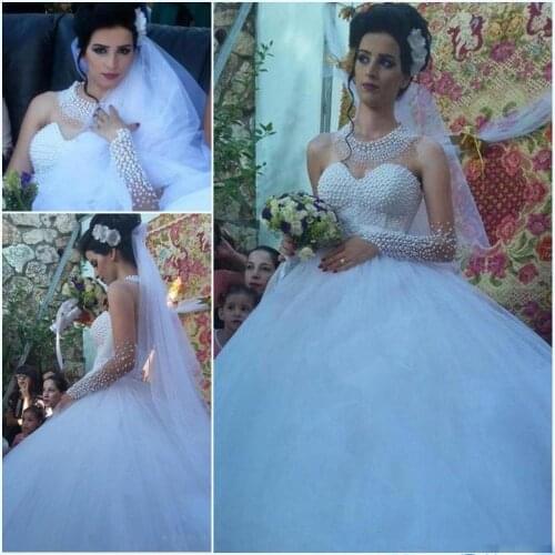 Luxury Pearls Beaded Dubai Arabic Wedding Dresses Bodice Illusion Long Sleeve Heavy Beading Bridal Gown Backless Tulle Ball Gown