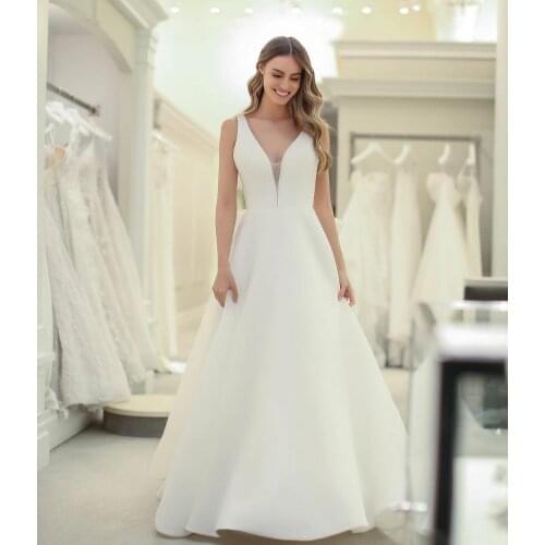 Elegant A-Line Long V-Neck Wedding Dresses with Pockets Ivory Open Back with Bow Satin Robes De Mariée Bridal Gown For Women