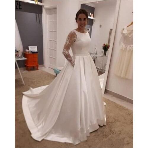 2020 Simple Elegant Satin Wedding Dresses Scoop Neck Illusion Long Sleeves Button Back Pockets Bride Dresses Robe De Mariee