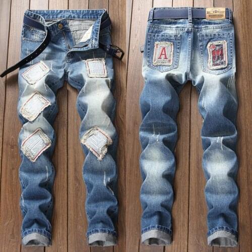 Men’s Chinese words patched blue jeans ripped slimming denim pants scratched casual jeans pants poker embroidery trendy jeans