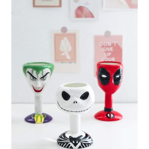 Halloween comics surrounding ceramic cups, red wine glasses, goblet ornaments, gifts