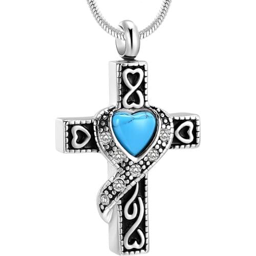The cremation cross is set with green gems. The top has holes to fill a small amount of ashes but enough to commemorate