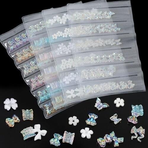 1 Pack 48/54PCS 3D Mix White Flowers Glitter Aurora Bear Skirt Butterfly Bowties Arylic Nail Art Rhinestone Decorations Manicure