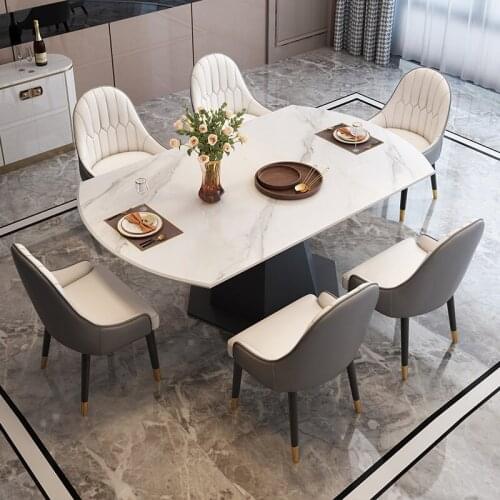The slate dining table is round with a retractable rotating circular dining room deformed table