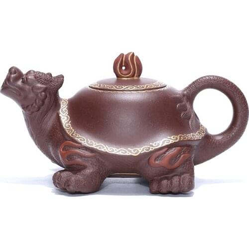 Yixing purple clay teapot is made by hand. Its a raw purple clay teapot and a dragon turtle teapot