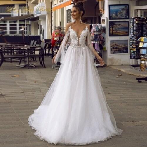 2020 New Sexy Backless Wedding Dress V Neck Lace Appliques Glitter Tulle Open Back Bridal Gowns with Ribbons Tv07