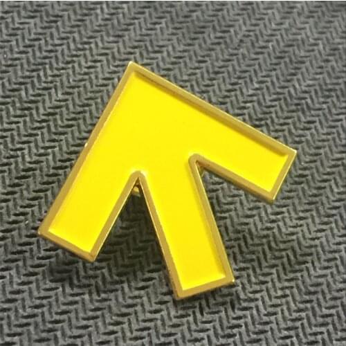 Collection of metal yellow arrow direction lapel yellow paint badges